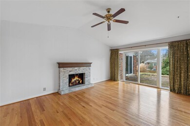 Vaulted family room with fireplace, hardwood floor