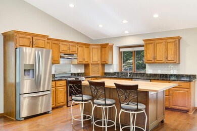 Stunning kitchen showcases large center island and charming kitchen window. Kitchen ceiling lights on south side of island.