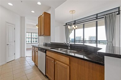 Kitchen with dishwasher, a sink, brown cabinets, d