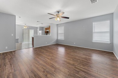 Unfurnished living room with ceiling fan and dark