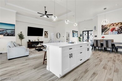 Kitchen with ceiling fan with notable chandelier,