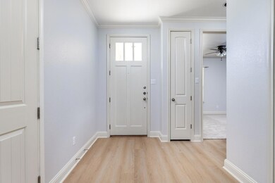 Entrance foyer with light wood-type flooring, cro