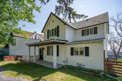 Rear view of house with a lawn