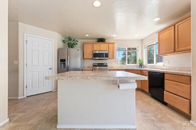 Kitchen with stainless steel appliances, a center island, light countertops, and recessed lighting