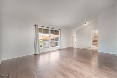  featuring wood finished floors, lofted ceiling, and stairs