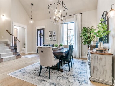 Dining area featuring high vaulted ceiling, an inv