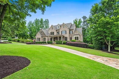 French country home with stone siding and a front lawn