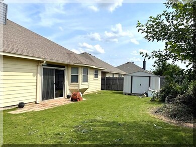 NICE BACKYARD WITH STORAGE BUILDING!