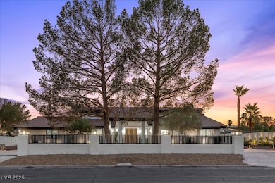View of front of house with stucco siding and a fe