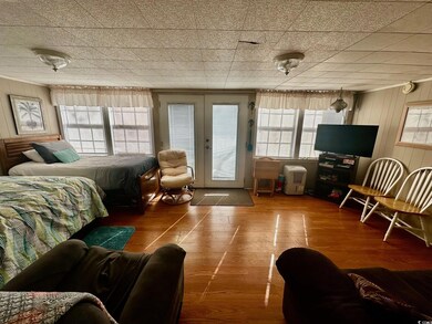 Bedroom featuring access to exterior, french doors