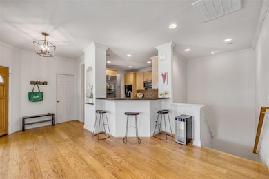 Kitchen with stainless steel microwave, light bro
