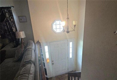 Foyer featuring a chandelier