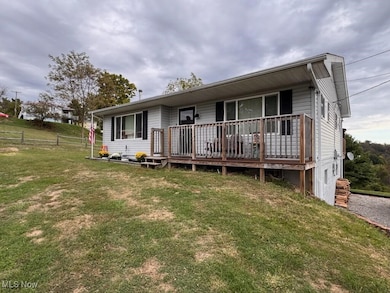 Back of house featuring a wooden deck