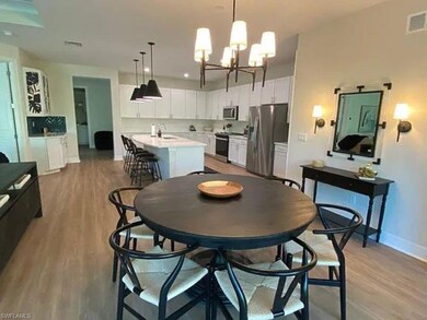 Dining space with a chandelier, baseboards, and li