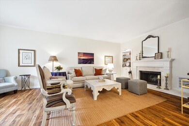 Cozy up around the fireplace featuring a detailed