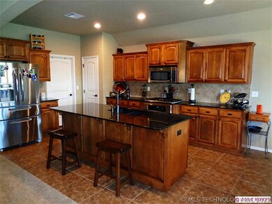 The kitchen island has the sink and a sit at bar.