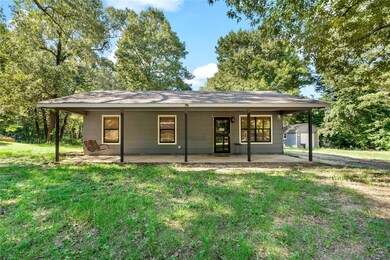 Ranch-style home featuring a front yard and a porc