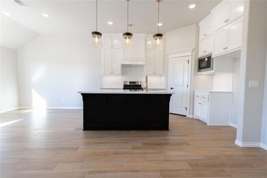 Kitchen featuring decorative light fixtures, white