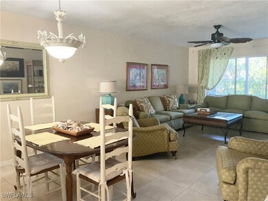 Dining and living area with light tile, ceiling fa