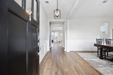 Foyer entrance with wood-type flooring and an invi