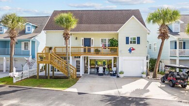 View of front facade featuring a garage and a carport