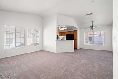 Unfurnished living room featuring lofted ceiling,