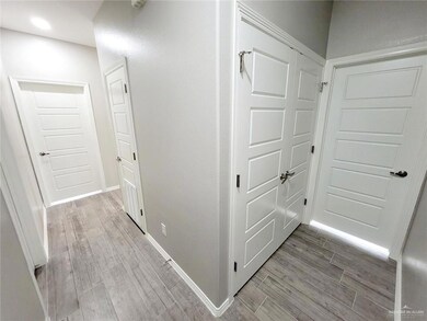 Corridor with light wood-style flooring