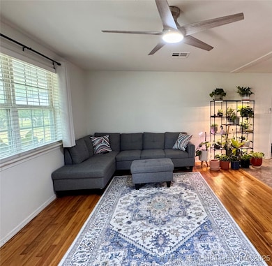 Bright living room with ceiling fan on dimmer