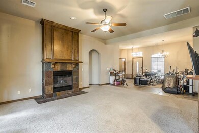 Carpeted living room featuring ceiling fan with no