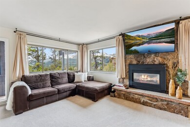 Living room with carpet flooring, a fireplace, and