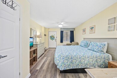 Bedroom featuring a ceiling fan, a textured ceilin