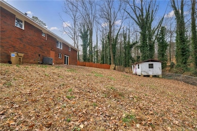 View of yard featuring a shed and central AC