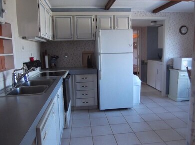 Kitchen with entry to laundry.