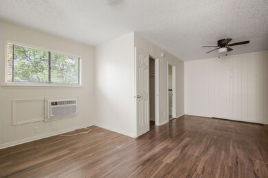 Empty room featuring a textured ceiling, a wall m