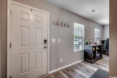 Foyer entrance featuring light wood-style flooring and baseboards