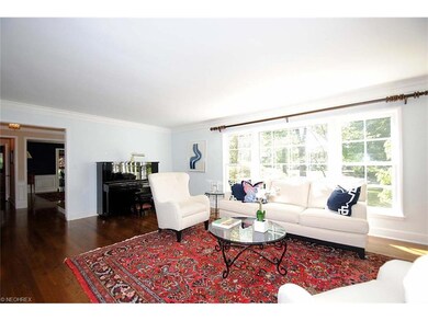 Light filled living room with fireplace, mantle an