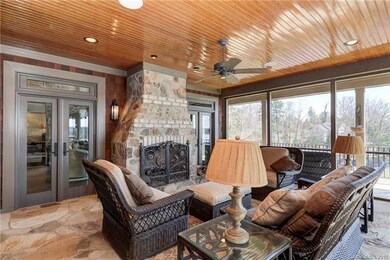 Screened patio with stone fireplace, enjoy the lak