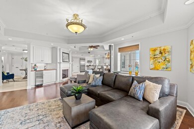 Living area with a ceiling fan, a raised ceiling, 