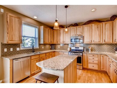 The kitchen features hickory cabinetry, granite co