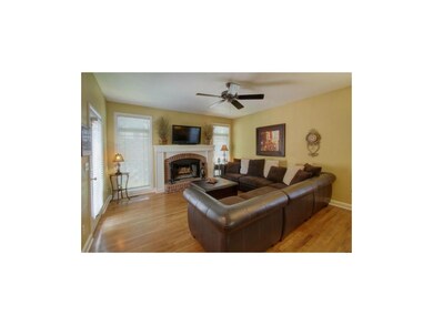 Hearth w/ hardwood floor and a door to the back pa