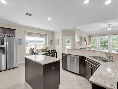 The kitchen features stainless steel appliances and open to the living room.