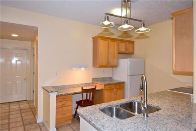 The galley style kitchen features granite counters