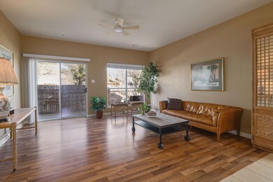 Living area with a ceiling fan, visible vents, ba