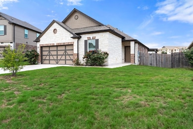 View of front of home featuring stone siding, con