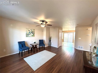 Sitting room featuring baseboards, ceiling fan wit