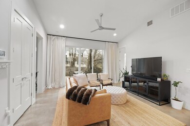 Living room with visible vents, recessed lighting
