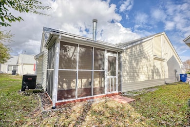 Rear view of house featuring a yard, cooling unit,
