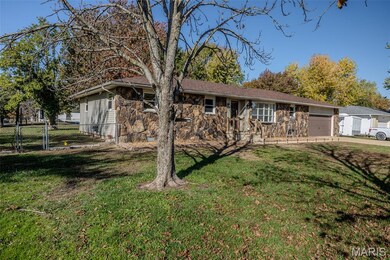 Single story home with stone siding and a gate