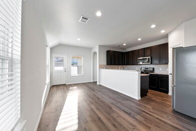 view of the kitchen + dining space. The opening in