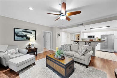 Living room with a ceiling fan, crown molding, recessed lighting, and light wood-type flooring